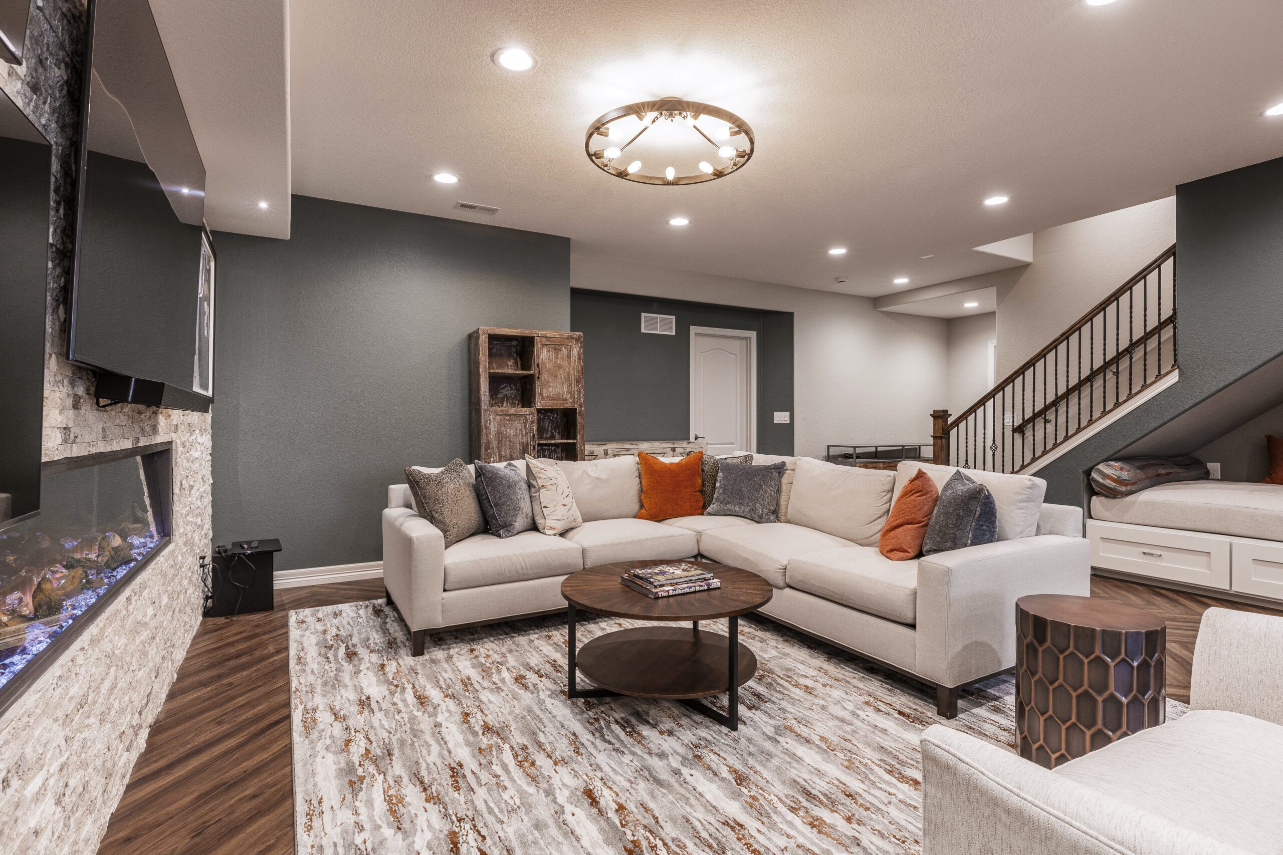 Finished basement renovation with modern design and comfortable seating area.