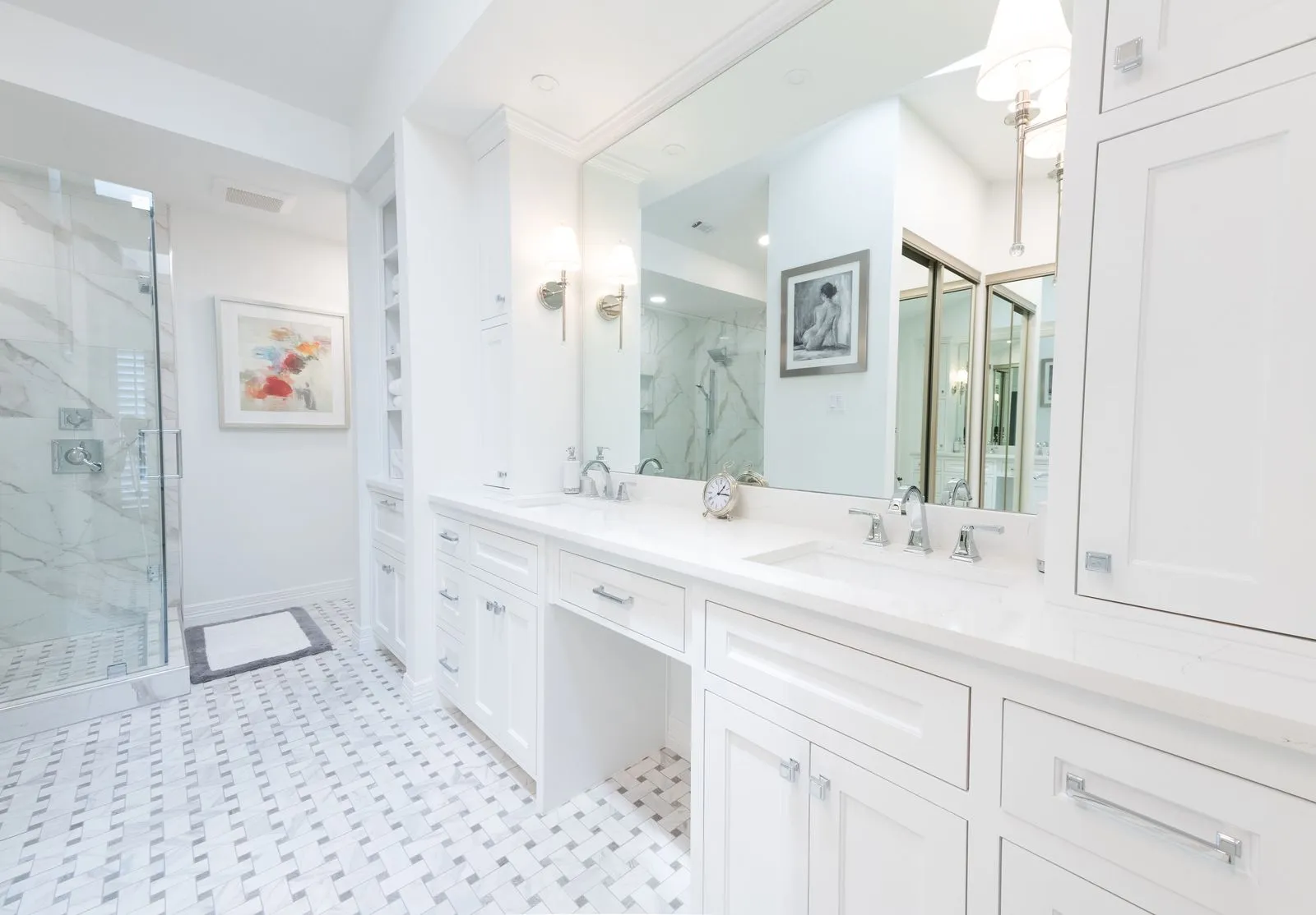 Luxury bathroom renovation with custom vanity, tile shower, and modern lighting by BCT Contractors.