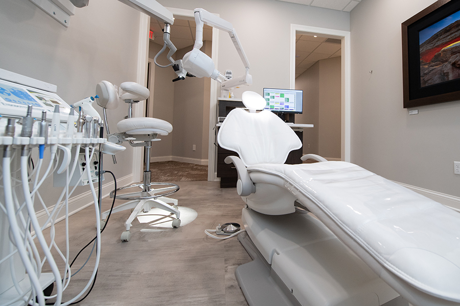 Modern dental office treatment room with dental chair and equipment, BCT Contractors renovation.