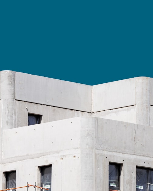Concrete structure corner with windows, representing commercial construction and renovation services by BCT Contractors.