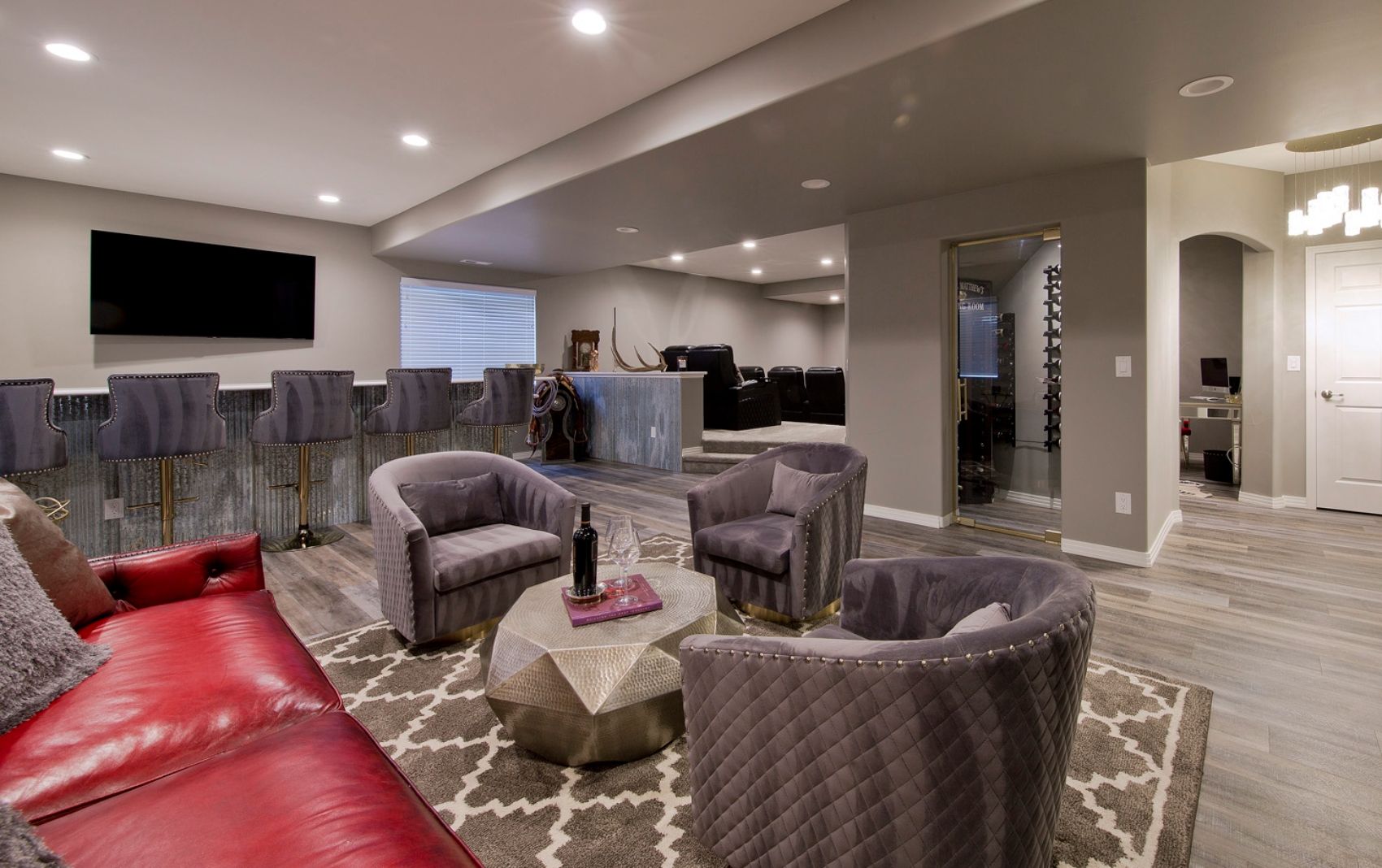 Luxury finished basement design with modern bar and entertainment area by BCT Contractors.